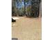 Large backyard featuring mature trees, offering shade and privacy on a sunny day at 1172 Sheffield Ct, Jonesboro, GA 30238
