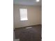 Bright bedroom with neutral carpet, white walls, and a window at 1172 Sheffield Ct, Jonesboro, GA 30238