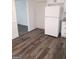 Kitchen with new wood-look flooring, white cabinets, and a white refrigerator at 1172 Sheffield Ct, Jonesboro, GA 30238