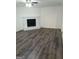 Open-concept living room featuring a brick fireplace and wood-look flooring at 1172 Sheffield Ct, Jonesboro, GA 30238