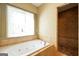 Bathroom features tile floors, soaking tub, and glass shower door at 4050 Old Fairburn Rd, Atlanta, GA 30349