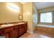 Bathroom features double sinks, tile floors, and a soaking tub under a window at 4050 Old Fairburn Rd, Atlanta, GA 30349