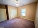 Carpeted bedroom with window, closet, and neutral walls at 4050 Old Fairburn Rd, Atlanta, GA 30349