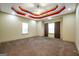 Large primary bedroom with elegant tray ceilings and ample natural light from multiple windows at 4050 Old Fairburn Rd, Atlanta, GA 30349