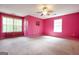 Spacious bedroom with neutral carpeting, bright pink walls, and plenty of natural light at 4050 Old Fairburn Rd, Atlanta, GA 30349
