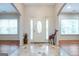 Bright foyer with decorative glass door, tile flooring, and hardwood floors at 4050 Old Fairburn Rd, Atlanta, GA 30349