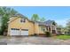 Home with a two-car garage and a mix of brick and siding, featuring a landscaped yard at 4050 Old Fairburn Rd, Atlanta, GA 30349