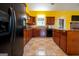 Eat-in kitchen featuring wooden cabinets, granite counters, and stainless steel appliances at 4050 Old Fairburn Rd, Atlanta, GA 30349