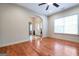 Open-concept living room with hardwood floors and arched entryway to the foyer at 4050 Old Fairburn Rd, Atlanta, GA 30349