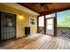 Covered wooden porch featuring a black smoker, and white doors at 4050 Old Fairburn Rd, Atlanta, GA 30349