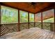 Covered porch with wood ceiling, lattice railing, and view of greenery at 4050 Old Fairburn Rd, Atlanta, GA 30349