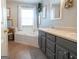 Well-lit bathroom with a double sink vanity, decorative mirrors, and a large tiled soaking tub at 500 Hayfield Ct, Locust Grove, GA 30248