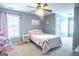Bright bedroom with plush carpet, soft pink bedding, and a ceiling fan for added comfort at 500 Hayfield Ct, Locust Grove, GA 30248