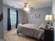 Cozy bedroom featuring cool gray walls, comfortable bedding, and a window with natural light at 500 Hayfield Ct, Locust Grove, GA 30248