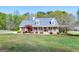 Charming brick home with a welcoming front porch and beautifully landscaped yard at 500 Hayfield Ct, Locust Grove, GA 30248