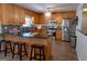 Modern kitchen with stainless steel appliances, granite countertops, and a breakfast bar at 500 Hayfield Ct, Locust Grove, GA 30248