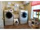Functional laundry room equipped with washer, dryer, utility sink, and ample storage at 500 Hayfield Ct, Locust Grove, GA 30248