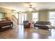Spacious living room with hardwood floors, staircase, and abundant natural light at 500 Hayfield Ct, Locust Grove, GA 30248
