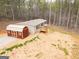 An aerial view of a home and a red storage shed surrounded by trees in a rural setting at 133 Springer Rd, Whitesburg, GA 30185