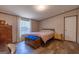 A cozy bedroom features wood-look floors, a comfortable bed, and natural light from the window at 133 Springer Rd, Whitesburg, GA 30185