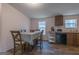 Dining area featuring a table with chairs, windows, and wood-look flooring at 133 Springer Rd, Whitesburg, GA 30185