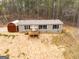 A one-story home with black framed windows and a brown shed at 133 Springer Rd, Whitesburg, GA 30185