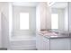 Clean bathroom with a tub, vanity, and a large mirror at 161 Aster Ave, Locust Grove, GA 30248
