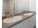 Bathroom vanity with double sinks and large mirror, plus neutral paint at 161 Aster Ave, Locust Grove, GA 30248