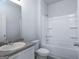 Bathroom featuring a single sink, toilet, and shower-tub combo at 161 Aster Ave, Locust Grove, GA 30248