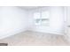 Bright bedroom featuring a window, carpet, and neutral colored walls at 161 Aster Ave, Locust Grove, GA 30248