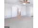 Cozy bedroom with neutral carpet, a ceiling fan, and two entry doors at 161 Aster Ave, Locust Grove, GA 30248