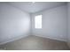 Bright bedroom with a carpet floor and a large window at 161 Aster Ave, Locust Grove, GA 30248