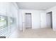 Bedroom with neutral paint and carpet, window, and open closet at 161 Aster Ave, Locust Grove, GA 30248