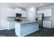 Modern kitchen with white cabinets, granite countertops, stainless steel appliances, and center island at 161 Aster Ave, Locust Grove, GA 30248