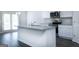 Bright kitchen with white cabinets, granite countertops, stainless steel appliances, and center island at 161 Aster Ave, Locust Grove, GA 30248