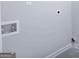 Clean laundry room area with hookups and neutral walls ready for customization at 161 Aster Ave, Locust Grove, GA 30248