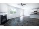 Spacious living room with a fireplace, ceiling fan, hardwood floors, and plenty of natural light at 161 Aster Ave, Locust Grove, GA 30248