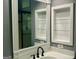 Bathroom featuring white vanity with stainless steel faucet and mirrored medicine cabinet at 9340 Basswood Way, Jonesboro, GA 30236