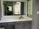 Bathroom vanity featuring gray cabinets, white countertop, mirror and stainless steel faucet at 9340 Basswood Way, Jonesboro, GA 30236