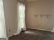 Neutral bedroom featuring carpet, natural light from window, and a shelf at 9340 Basswood Way, Jonesboro, GA 30236