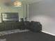 Bonus room featuring dark leather furniture and entertainment center at 9340 Basswood Way, Jonesboro, GA 30236
