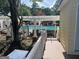 A beautiful community pool is accessible by a short wooden walkway and features a pergola for shaded seating at 9340 Basswood Way, Jonesboro, GA 30236