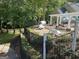 This community area includes lounge chairs, a covered grill and a pergola with tables for outdoor dining and entertaining at 9340 Basswood Way, Jonesboro, GA 30236