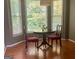 Cozy dining area with hardwood floors, views through large windows, and minimalist decor at 9340 Basswood Way, Jonesboro, GA 30236