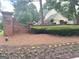 A brick entry monument leads to the charming house and the attached garage at 9340 Basswood Way, Jonesboro, GA 30236