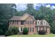 Beautiful brick home featuring traditional architecture and a well-manicured lawn and complementary landscape at 9340 Basswood Way, Jonesboro, GA 30236