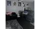 Basement media room space with black leather seating, movie posters, and dark carpet at 9340 Baswood Way, Jonesboro, GA 30236