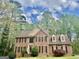 Charming two-story brick home with dormer windows and manicured landscaping at 9340 Baswood Way, Jonesboro, GA 30236
