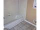 A standard bathtub in a bathroom with ceramic tiling at 1217 Dove Ct, Morrow, GA 30260