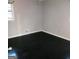 An empty room features dark wood floors and a window at 1217 Dove Ct, Morrow, GA 30260